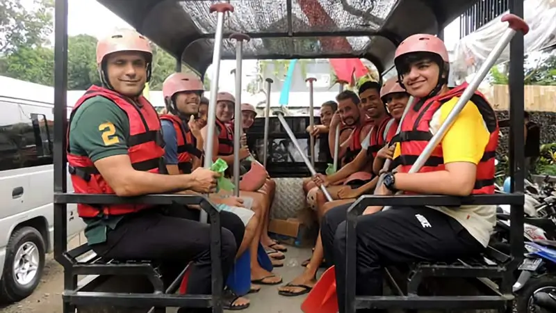 Guests in rafting gear riding the transfer vehicle before the trip