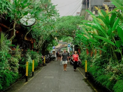 Travelers walking along a green pedestrian street in central Ubud