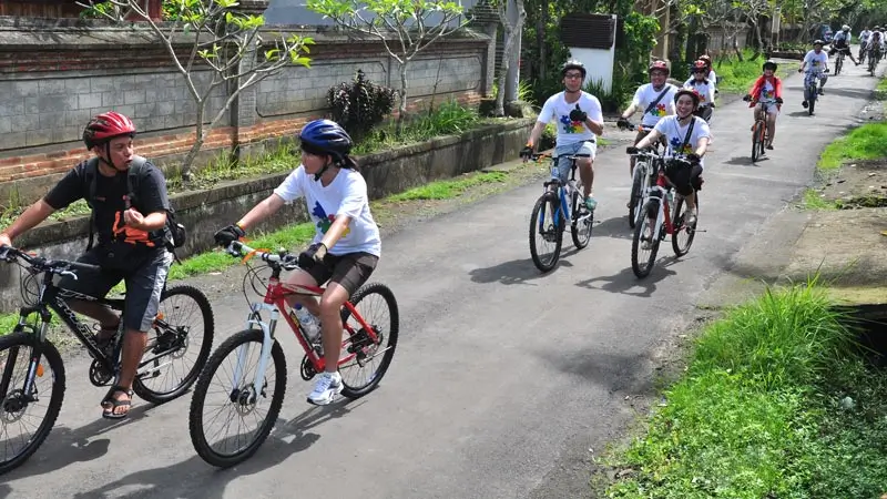 Group cycling on a village road during Sobek Ubud Cycling