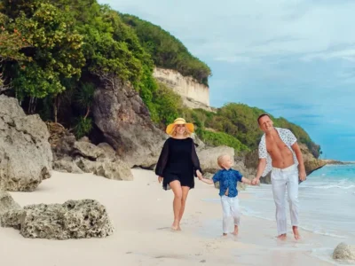 Family walking on a cliffside beach for a Bali family itinerary