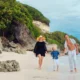 Family walking on a cliffside beach for a Bali family itinerary