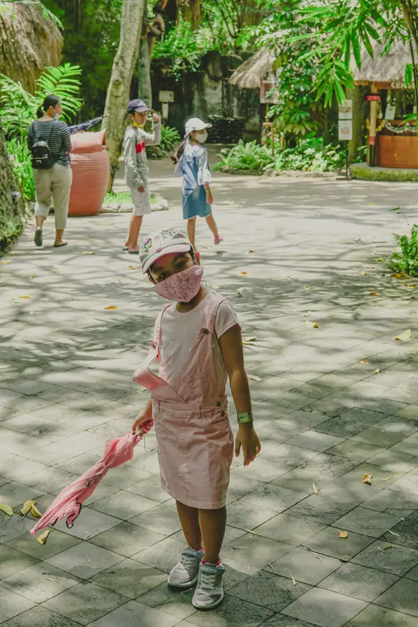 Child walking along a shaded pathway at Bali Safari