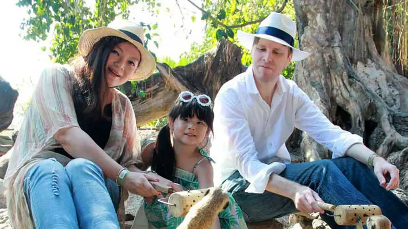 Family feeding meerkats during a supervised animal activity