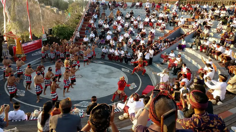Open-air amphitheater seating with audience during the show