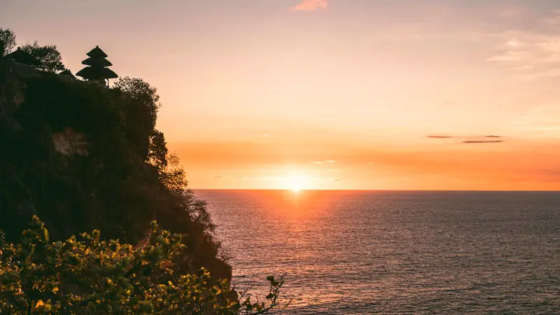 Sunset over the Indian Ocean beside Uluwatu Temple cliffs