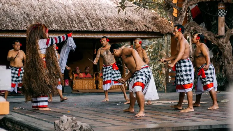 Performers carrying keris during a traditional Barong dance-drama in Bali