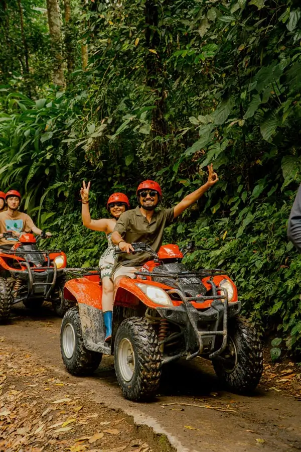 Two participants riding together on a forest trail
